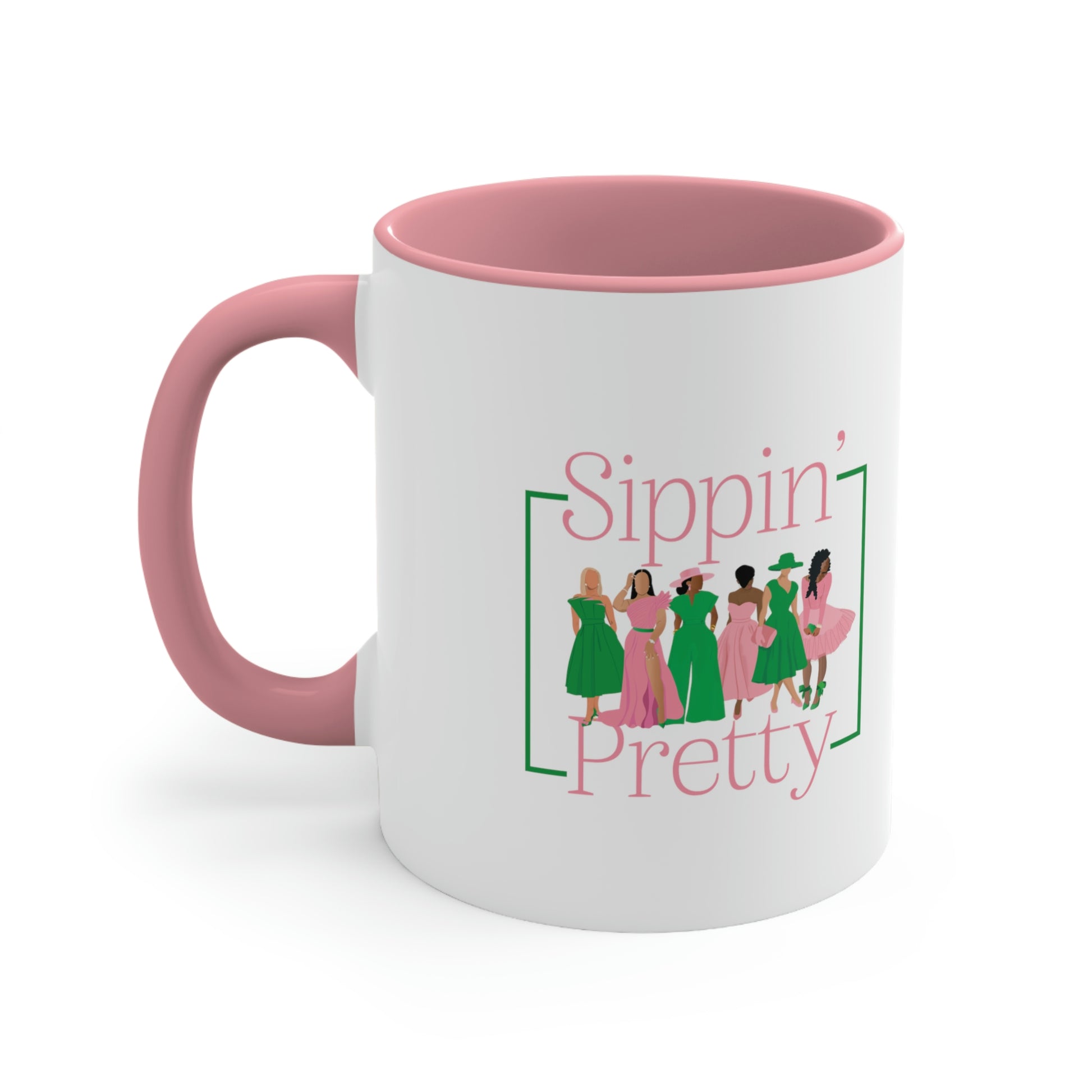 Side view of white ceramic mug with black women wearing pink and green outfits/Sippin' Pretty